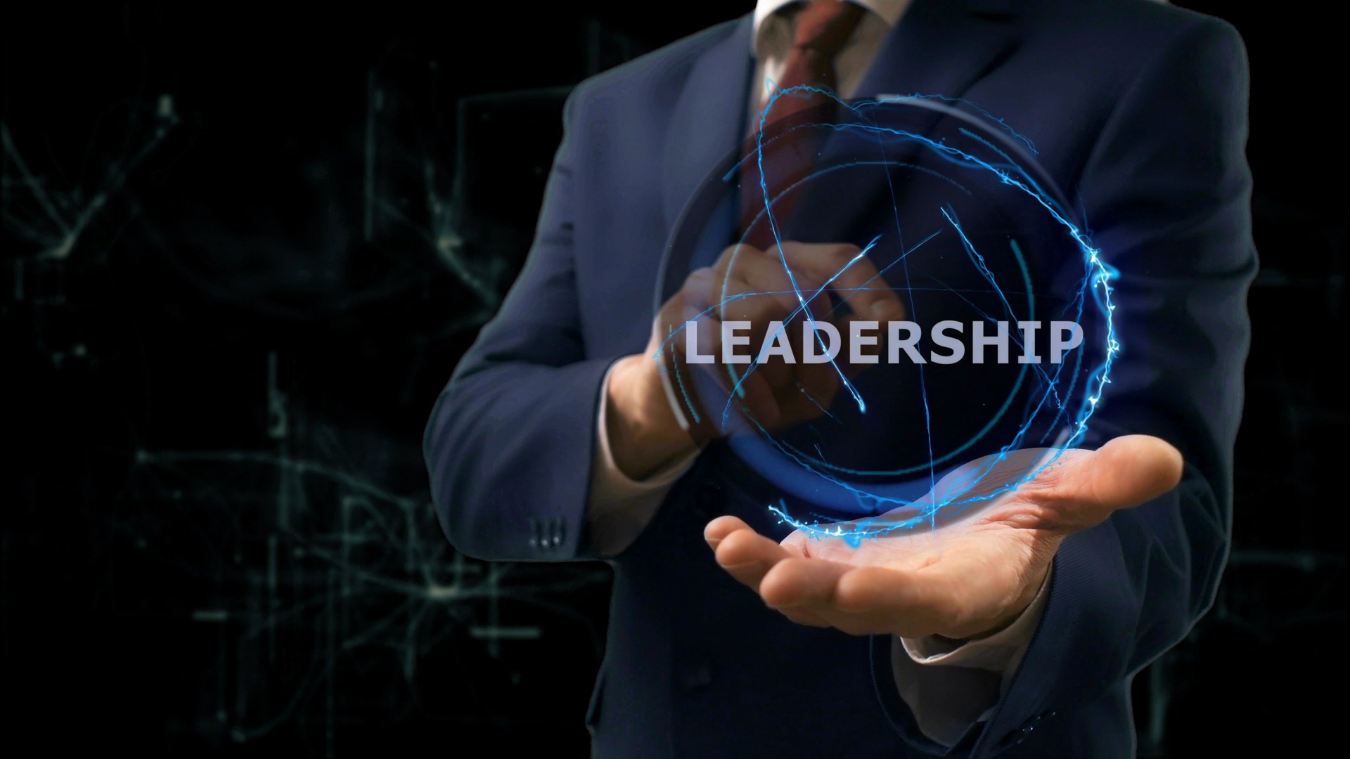 Businessman shows concept hologram Leadership on his hand